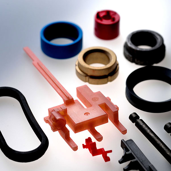Components made of plastic and metal, coated with bonded coating and dry lubrication.