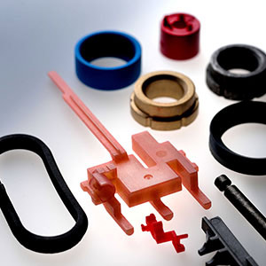 Components made of plastic and metal, coated with bonded dry film lubrication.